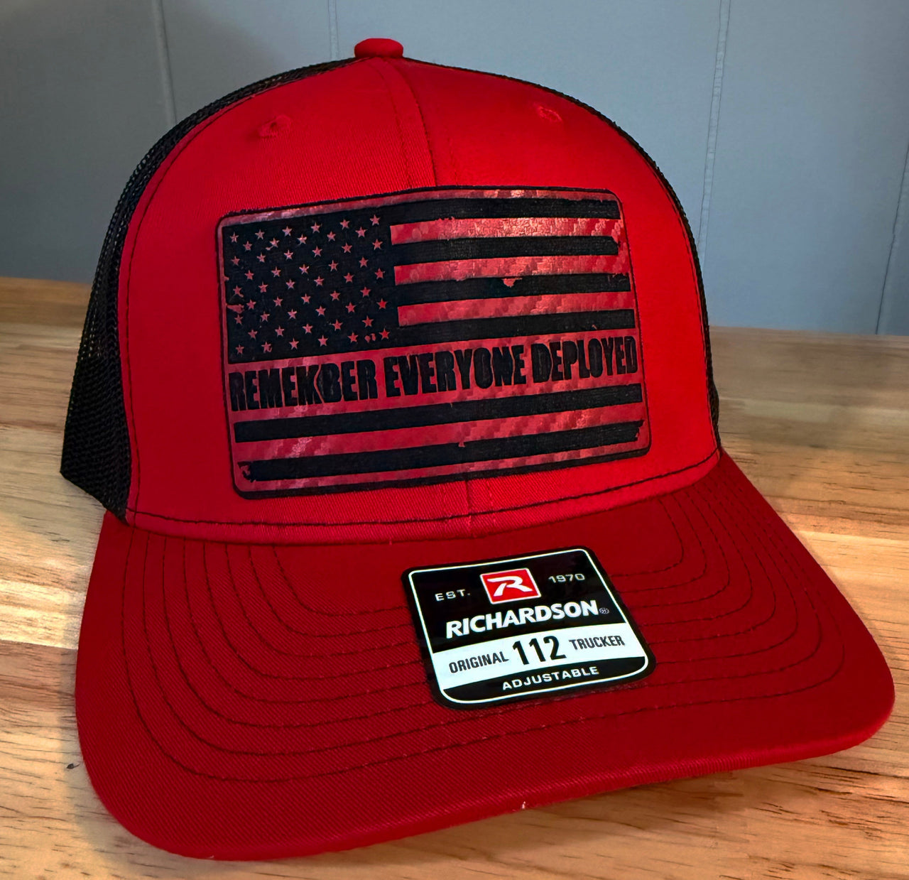 End of Shift Apparel red and black Richardson 112 trucker hat with an American flag Remember Everyone Deployed patch